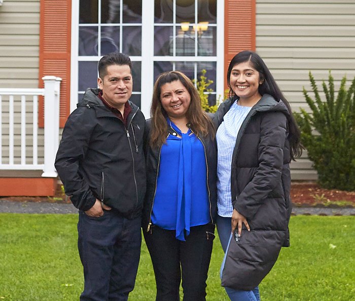 Family in front of Nault Housing Family in front of Nault Housing